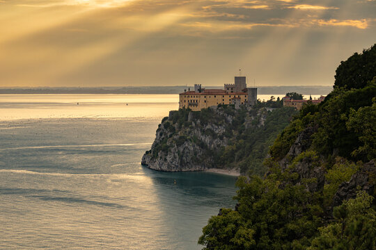 Sunbeams shining on Castello di Duino on the cliffs along the Adriatic coast. About 20 kilometers from Trieste, Duino Castle stands on the rocks overlooking the Adriatic Sea.