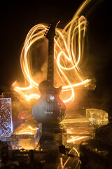 Music Concept: Guitar Miniature on a Dark Background with Vivid Light, Smoke, and Fire Effects. Golden electro guitar under a Dramatic Spotlight.
