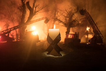 A tabletop diorama of a tragic California wildfire, set in Pacific Palisades near Malibu. Dramatic flames and smoke rise as firefighters battle the blaze