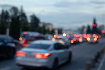 heavy urban traffic, cars' rear view at dusk/evening, red bokeh brake lights on a dark blue background, blurred rush hour, modern city