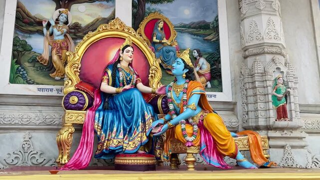 Beautiful sculpture showing Radha and Krishna embracing lovingly beside a river, symbolizing divine union and eternal love.