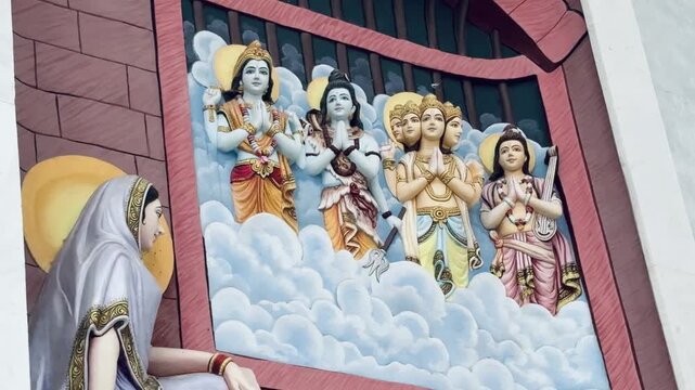 Lord Brahma, Lord Vishnu, and Lord Shiva &mdash; seated among divine clouds, symbolizing creation, preservation, and destruction. The vibrant relief artwork showcases exquisite craftsmanship, spiritual