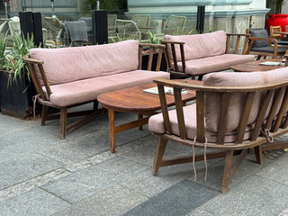 Outdoor cafe with wooden furniture. Relaxation, urban lifestyle, and social atmosphere captured through cozy design and street details.