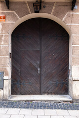 Designer entrance door to a country house. Modern design. Luxurious exterior. Facade of a modern building with modern doors.