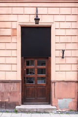 Designer entrance door to a country house. Modern design. Luxurious exterior. Facade of a modern building with modern doors.