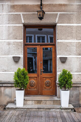 Designer entrance door to a country house. Modern design. Luxurious exterior. Facade of a modern building with modern doors.
