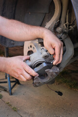 Car mechanic working on disc brakes