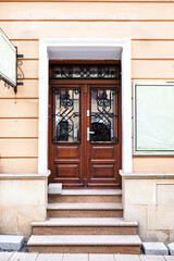 Designer entrance door to a country house. Modern design. Luxurious exterior. Facade of a modern building with modern doors.