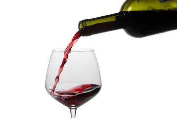 Red wine is poured from a bottle into a glass on a white background.