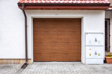Designer entrance gate to garage. Modern design. Luxurious exterior. Facade of a modern garage.