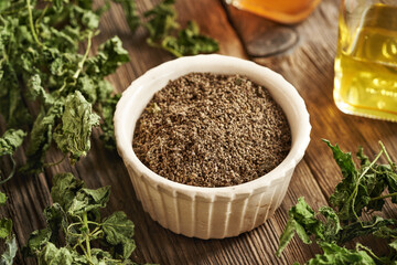 Dried stinging nettle seeds and leaves on a table