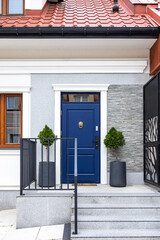Designer entrance door to a country house. Modern design. Luxurious exterior. Facade of a modern building with modern doors.