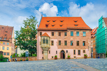 Medieval buildings on empty pedestrian square Sebalder Platz in Old town Nuremberg city historical center, Middle Franconia region, Bavaria state, Germany