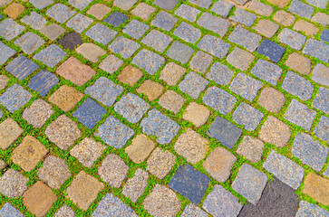Cobblestone road texture, abstract background of cobblestone pavement close-up, old street stone paved texture