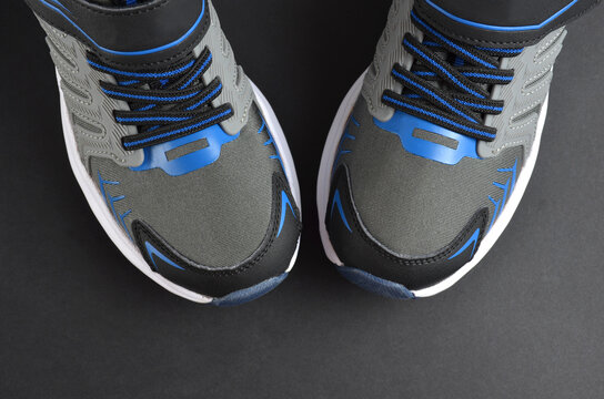 Gray-blue sneakers on a gray background.