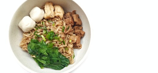 Mie Ayam Indonesian Chicken Noodle Soup with Fish Balls in a Bowl Isolated on White Background. Food Photography