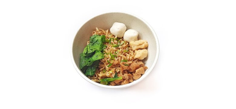 Mie Ayam Indonesian Chicken Noodle Soup with Fish Balls in a Bowl Isolated on White Background. Food Photography