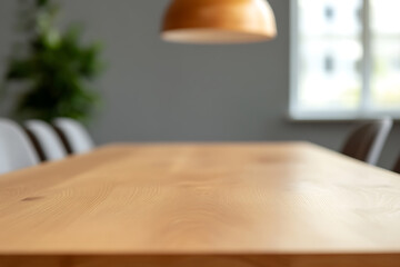An inviting view of a wooden table and light fixture sets a warm tone. Chairs surround, offering a space for gathering, overlooked by a window and potted plant.