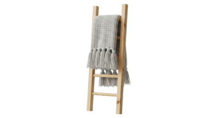 Cozy gray knit blanket on wooden ladder with tassels