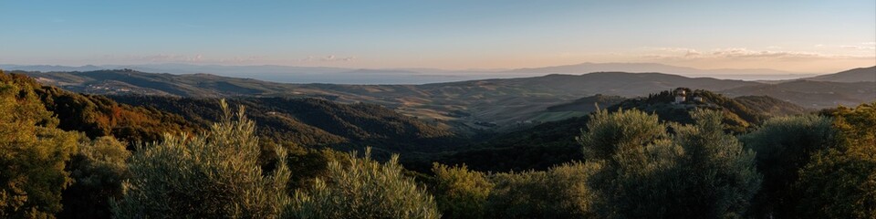 Fototapeta premium Scenic tuscan landscape at sunset with hills and distant sea view