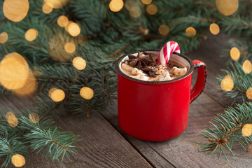 Christmas hot chocolate, coffee or cacao with marshmallows and candy cane. Xmas festive cozy beverage. Traditional beverage for kids.