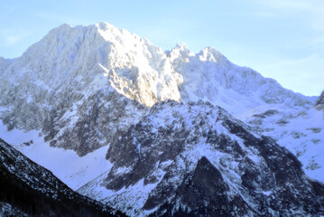 Obraz premium Snow-covered mountain peaks in morning sunlight
