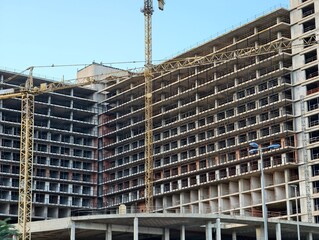 ongoing building with safety emphasis, active construction showing structural details and safety
