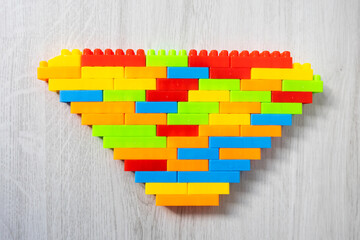 Assembled multi-colored plastic construction blocks lie on the floor.