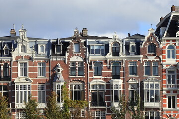 Fototapeta premium Weesperzijde Ornate House Facades with Autumn Foliage in Amsterdam, Netherlands