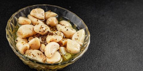 Garlic slices in flavored oil roasted garlic slice in oil fast food natural tasty appetizer fresh delicious gourmet food background on the table rustic top view copy space vegetarian or vegan food