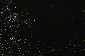 Abstract macro glitter texture in black background