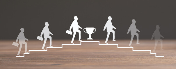 Businessman walking on stairs. Walking down stairs after reaching the trophy