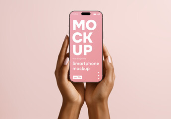 Smartphone mockup held in hands on pastel background