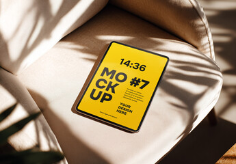 Tablet mockup on beige sofa in natural sunlight