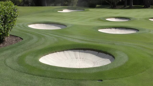 Backgrounds Composed of a Golf Course Putting Surface of Green Grass and a Bunker Filled with Pale