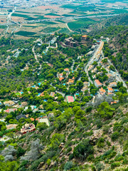 Vibrant landscape showcasing a picturesque village nestled in lush greenery during a bright, sunny day in the countryside