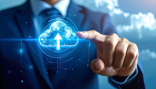 Man touching glowing cloud upload icon in front of a blurred cloud background, wearing a suit