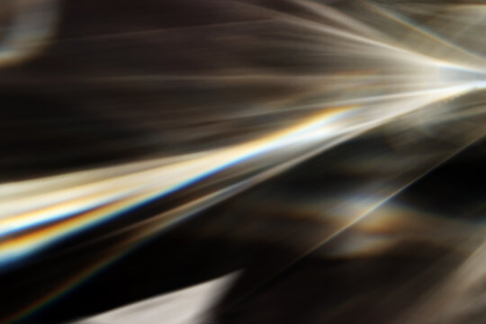 Blurred Caustic effect light refraction on surface overlay, sun rays refracting through glass prism. Abstract natural shine light pattern. Sunlight Light Leaks, flares, glares. Blurry beams caustics