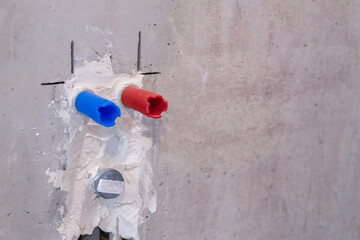 PEX plastic water supply plumbing pipe in wall of house.