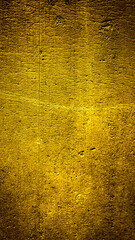 wall painted with gold paint with an interesting texture