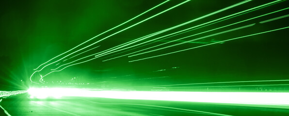 green car lights at night. long exposure
