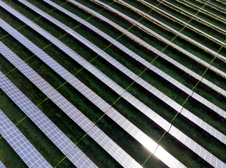 Aerial view of a solar farm producing clean renewable sun energy, industrial landscape