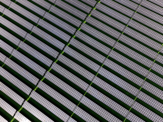 Aerial view of a solar farm producing clean renewable sun energy, industrial landscape