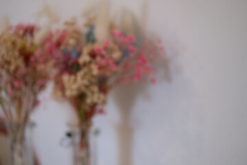 Soft blurred composition of dried flowers in pastel tones, ideal as a background for design, posters, social media, and branding.