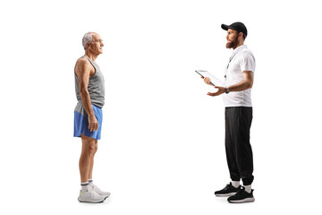 Full length profile shot of a sports coach talking to a senior man in sportswear