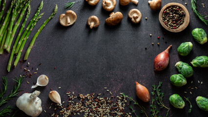 Various fresh whole raw organic ingredients arranged in a frame with copy space.