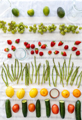 Rows of fresh vinegar washed fruits and vegetables drying on a towel.