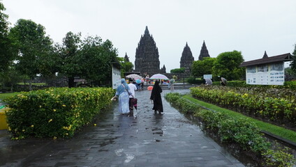 Visitors Walking Toward Ancient Temple on Rainy Day