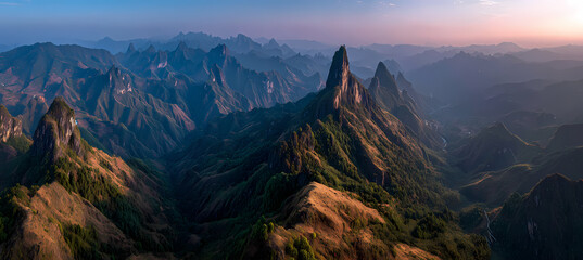 Serene mountain landscape at sunrise with misty blue and pink tones