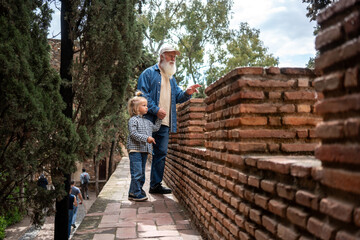 Grandfather and grandson exploring ancient ruins together